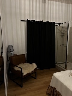 Private room seating nook beside the glass shower
